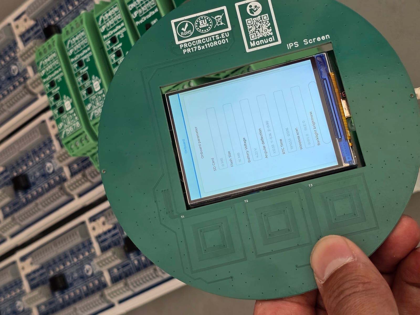 Prototype with LCD and touch buttons behind thick glass, with DIN rail modules behind it